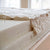 Spindle mattress cut open to show organic cotton fabric, organic wool batting, and then nine-inches of organic latex